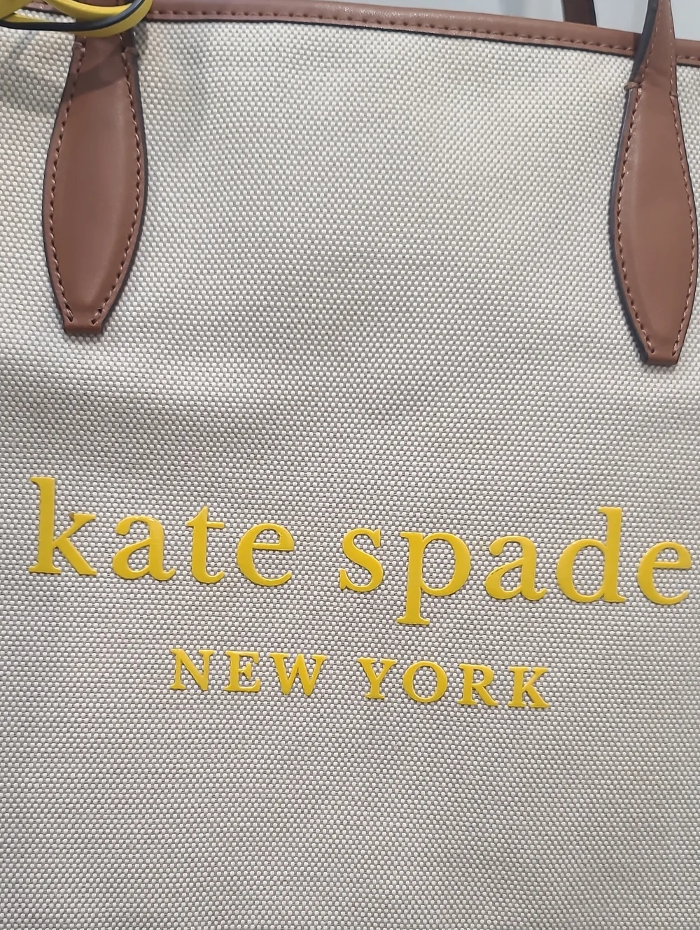 kate spade Beige Canvas Tote with Brown Trim and Yellow Charm